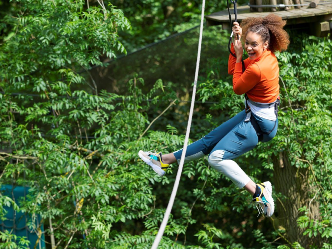 Woman on rope swing in the trees